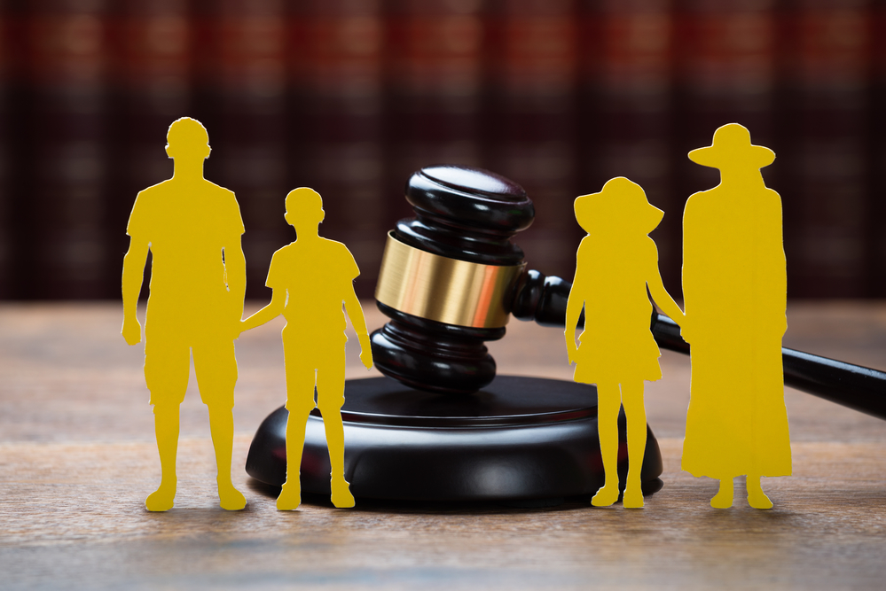 paper family with mallet on table in courtroom